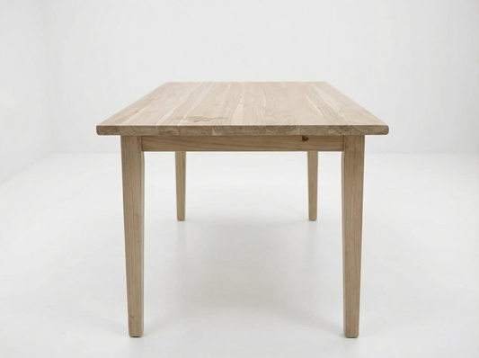 Haven small solid teak dining table on a white background