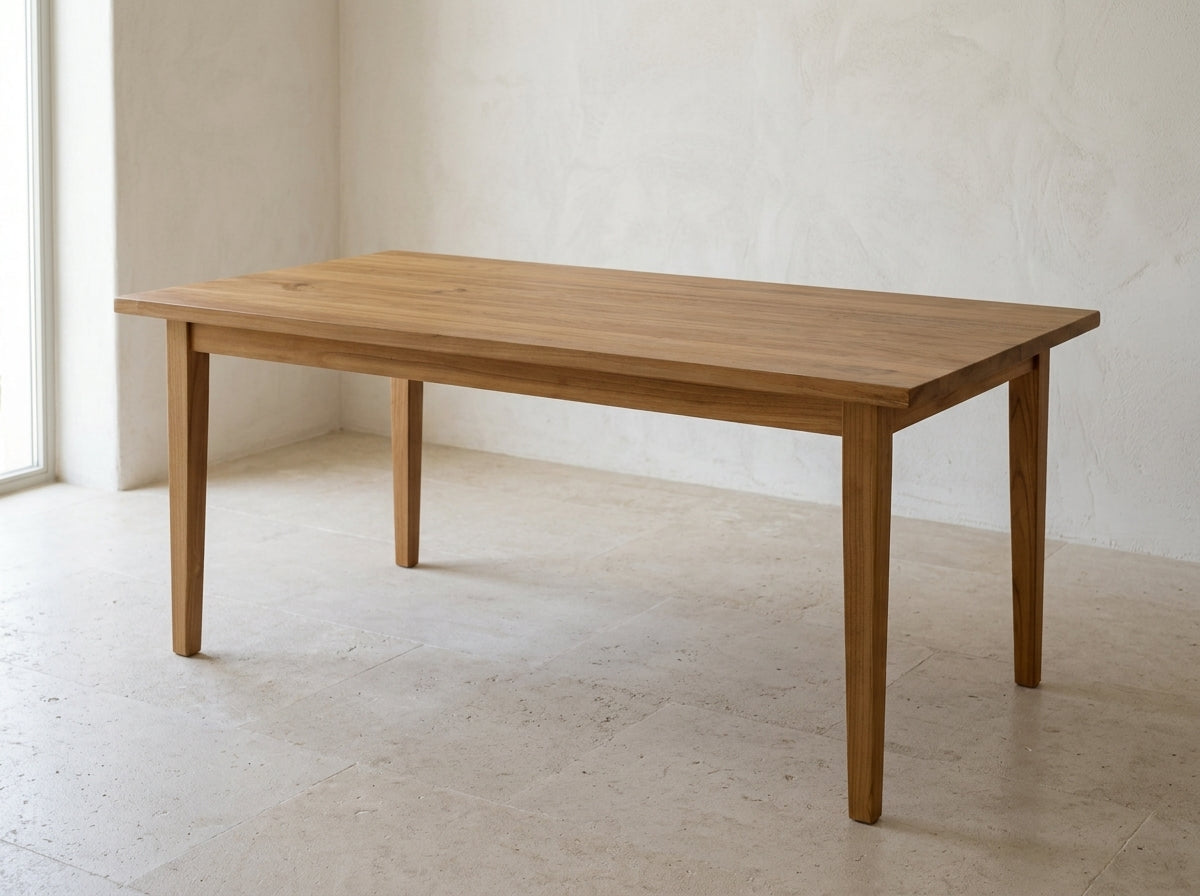 Haven 160 cm solid teak dining table in a warm natural finish, shown in a light Mediterranean interior